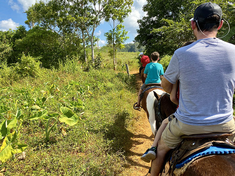 Riding horses through Vinales Valley