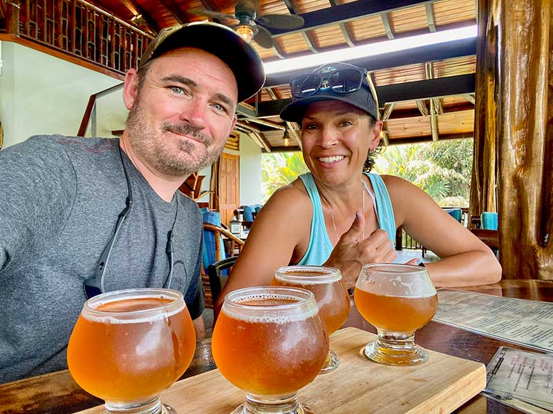 Craig and Cody smiling with a flight of beers at Fuego Brewery